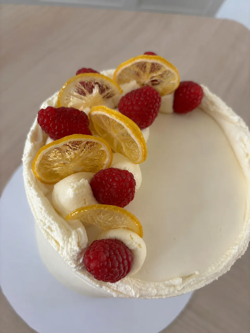 Close-up of the lemon slices and raspberries on Le Mon’s buttercream cake
