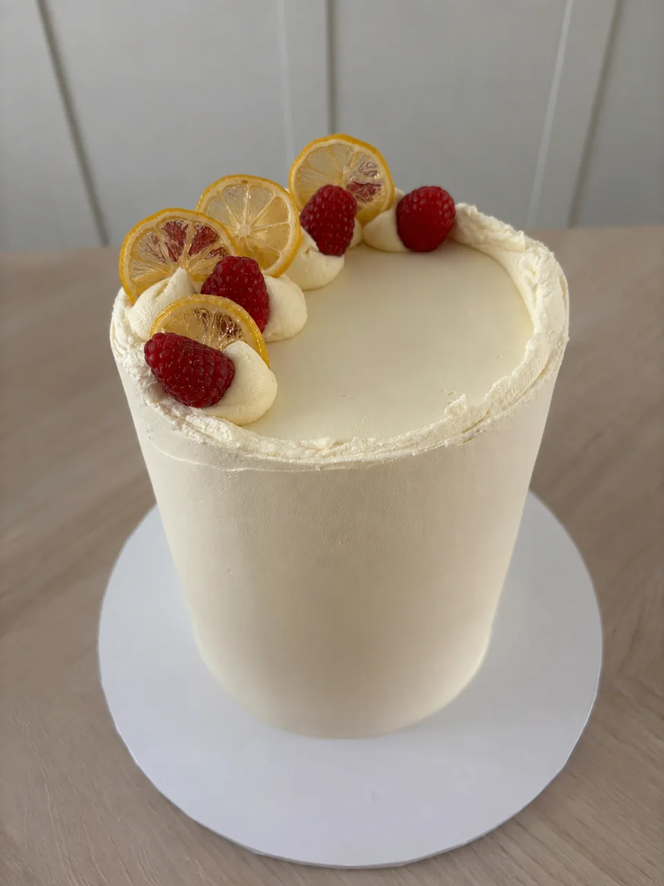Le Mon’s ivory buttercream cake with dried lemons and fresh raspberries